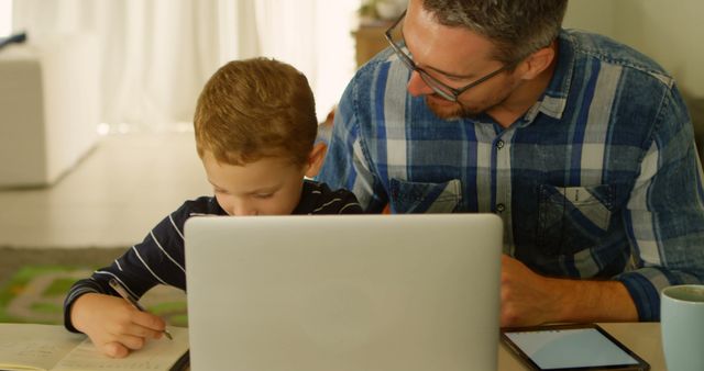 Father Helping Son with Homework at Laptop - Download Free Stock Images Pikwizard.com