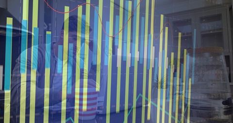 Mid-adult man analyzing financial bar charts and trend lines overlaying cafe workspace