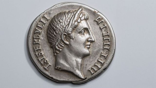 Antique silver medallion featuring roman emperor portrait with laurel crown and inscribed rim