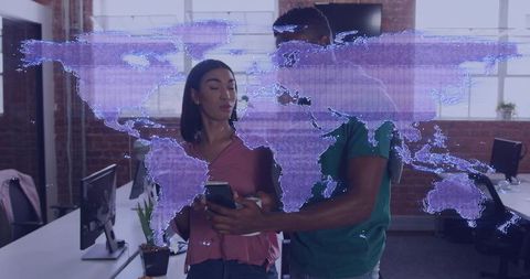 Team collaborating over mobile with holographic world map overlay in open-plan office