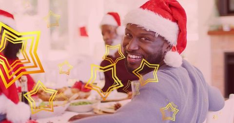 Smiling Family in Santa Hats Enjoying Festive Christmas Dinner