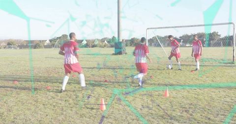 Four players dribbling near goal during soccer training with teal graphic overlay