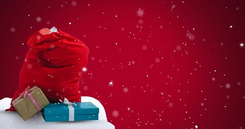 Snow Falling on Christmas Presents and Gift Bag with Red Background
