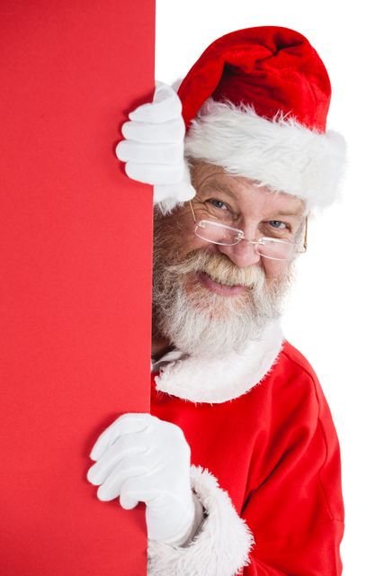 Santa Claus peeking from a red board on a white background. Perfect for holiday promotions, Christmas cards, festive advertisements, and seasonal marketing materials. The cheerful expression and traditional costume add a joyful and merry touch to any holiday-themed project.