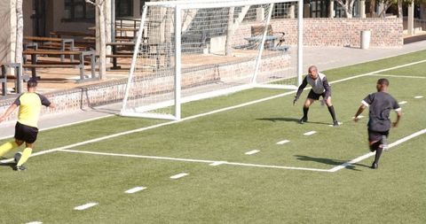 Intense soccer match with players on field during goal attempt