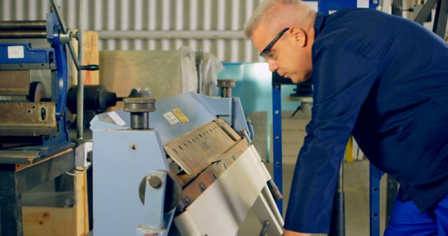 Senior Engineer Operating Industrial Machine in Factory Workshop - Download Free Stock Images Pikwizard.com