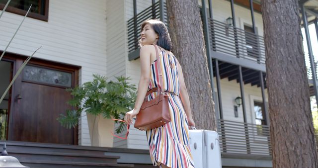 Woman Arriving at Modern Home with Luggage and Shoulder Bag - Download Free Stock Images Pikwizard.com