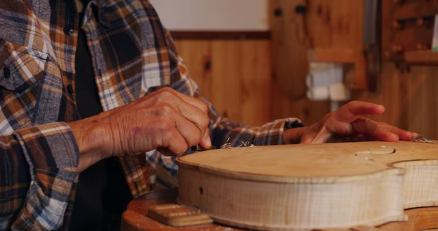 Craftsman Working on Wooden Musical Instrument in Workshop - Download Free Stock Images Pikwizard.com