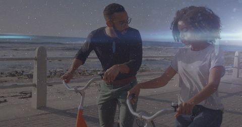 Young Couple Walking with Cruiser Bikes on Seaside Boardwalk during Golden Hour Conversation