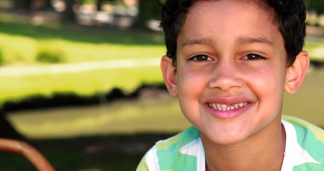 Smiling Boy with Curly Hair Enjoying Outdoors - Download Free Stock Images Pikwizard.com