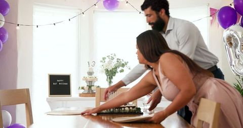 Couple Cleaning Up After Family Celebration at Home