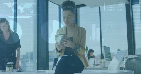 Businesswoman with digital data visualization in modern office