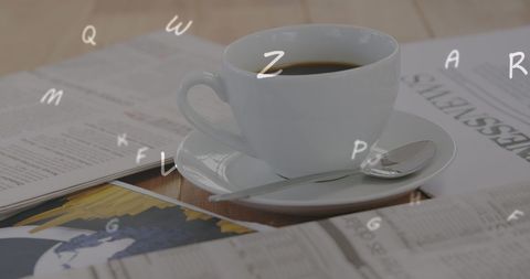 Coffee Cup with Floating Alphabet over Documents