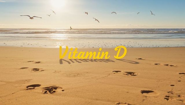 Sunlight bathing sandy beach with footprints, seagulls and bold Vitamin D text overlay