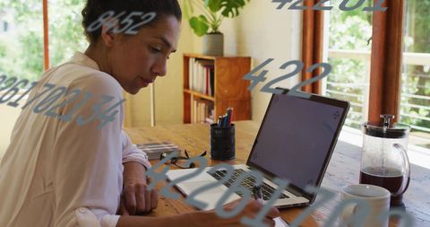 woman writing notes at desk in home office with laptop - Download Free Stock Images Pikwizard.com
