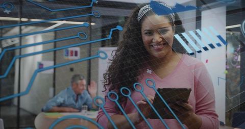 African American Woman Using Tablet in Modern Office with Digital Interface