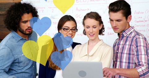 Diverse Team Collaborating in Office with Overlayed Hearts
