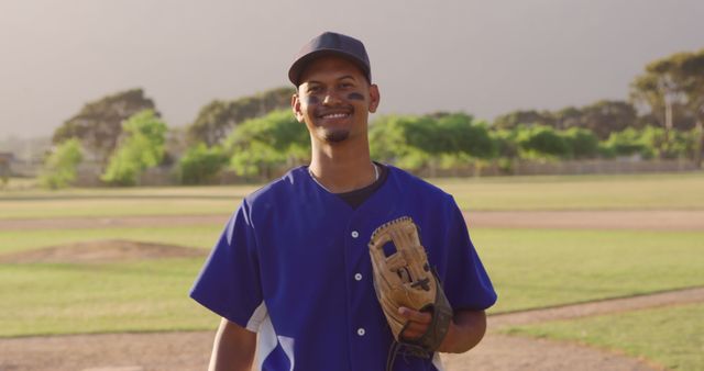 Smiling Baseball Player Standing With Glove in Sunny Field - Download Free Stock Images Pikwizard.com