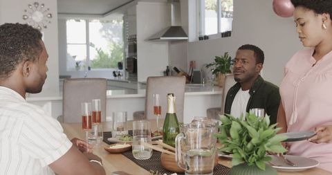 African American Friends Sharing Meal in Modern Kitchen