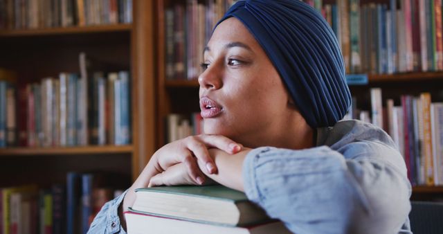 Young Woman in Turban at Library Relaxing on Books - Download Free Stock Images Pikwizard.com