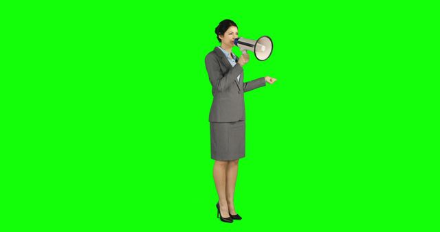 A middle-aged Caucasian businesswoman is speaking into a megaphone, with copy space. Her professional attire and confident stance suggest she's making an important announcement or directing a team.