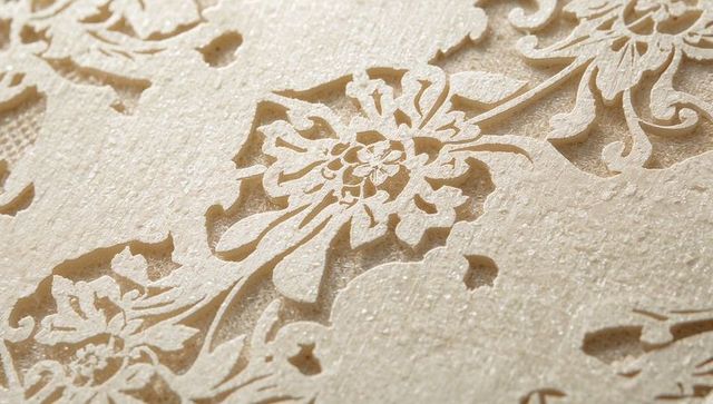 Revealing embossed damask wallpaper with floral relief and visible paper fibers