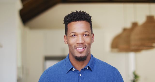 Smiling Young Man in Casual Blue Shirt at Home - Download Free Stock Images Pikwizard.com