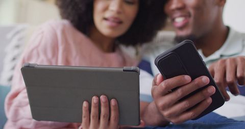 Couple Enjoying Quality Time with Tablet and Smartphone at Home