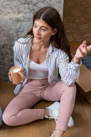 Relaxed woman with coffee mug in cozy home interior setting