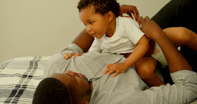 Father Enjoying Quality Time With Smiling Toddler on Bed - Download Free Stock Images Pikwizard.com