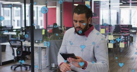 Using Tablet and Glass Partition with Digital Collaboration Icons in Modern Coworking Space