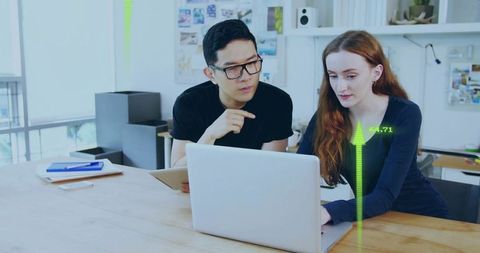Diverse Colleagues Using Laptop with Digital Interface Visuals