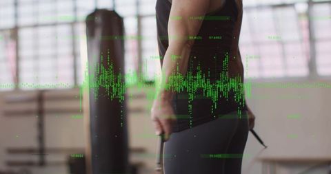 Skipping rope workout in gym with green data overlay showing fitness analytics and cardio