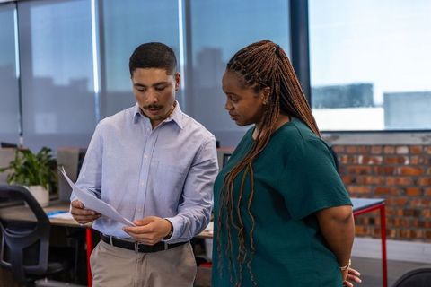 Creative Professionals Discussing Documents at Modern Office