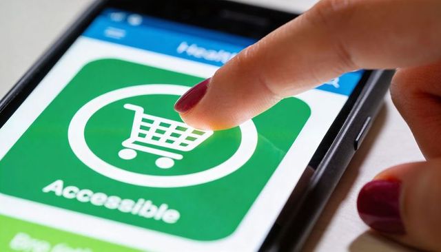 Tapping Accessible Shopping App Icon on Smartphone by Woman with Purple Nails