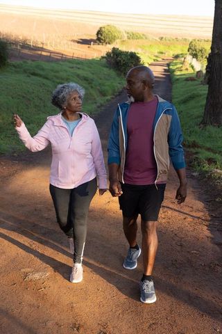 Senior African American Couple Walking on Scenic Rural Trail