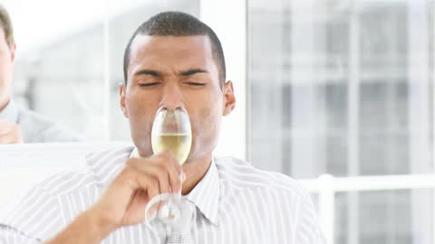 Professional Confident Businessman Enjoying Glass of Champagne