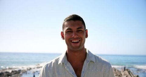 Joyous Young Man Smiling on Sunny Beach Day - Download Free Stock Images Pikwizard.com