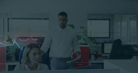 Manager reviewing reports with colleague in modern open office with data chart overlay