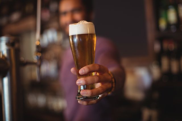 Bartender Serving Fresh Beer at Bar - Download Free Stock Photos Pikwizard.com