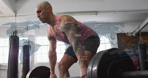 Muscular athlete lifting heavy barbell in industrial gym with hud world map overlay