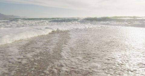Sunlit Sea Waves Crashing on Sand at Serene Beachside - Download Free Stock Images Pikwizard.com