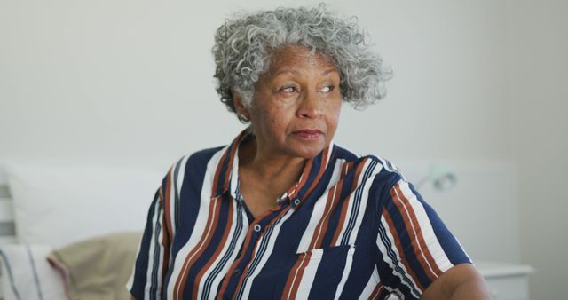 Serious african american senior woman looking into distance. active and healthy retirement lifestyle at home.