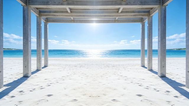 Sunlit pergola framing turquoise ocean over pristine white sand beach