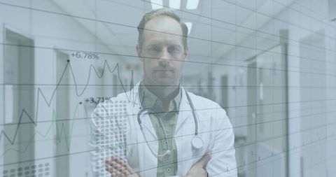 Doctor analyzing percentage graphs in hospital corridor