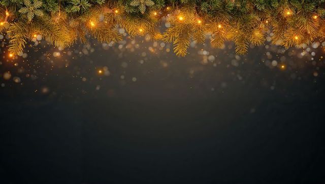 Glowing evergreen garland shimmering with warm string lights and golden bokeh