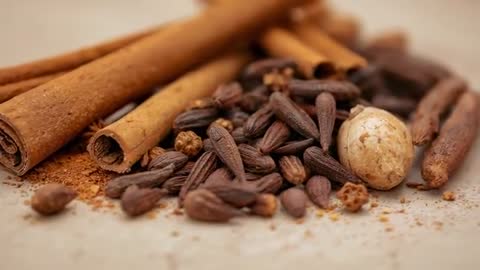 Pulling Back Racking Focus Revealing Warm Macro Video of Cinnamon Sticks, Clove Buds