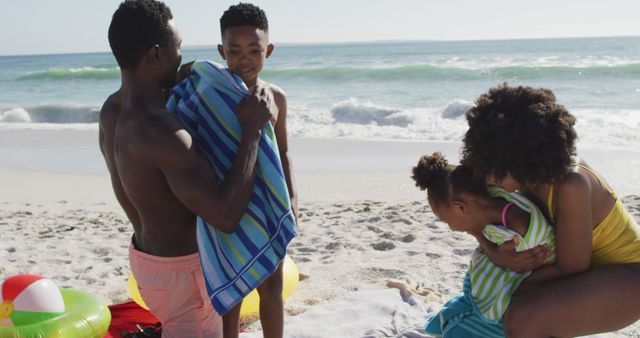 Family Enjoying Day at Beach with Children Wrapped in Towels - Download Free Stock Images Pikwizard.com