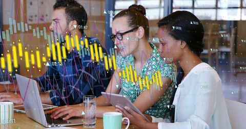 Multicultural team collaborating on financial data with interactive market charts overlay