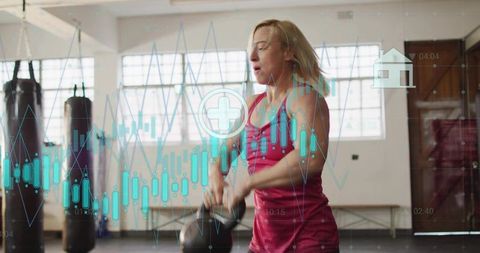 Woman lifting kettlebell in gym with fitness data overlay showing training analytics and strength